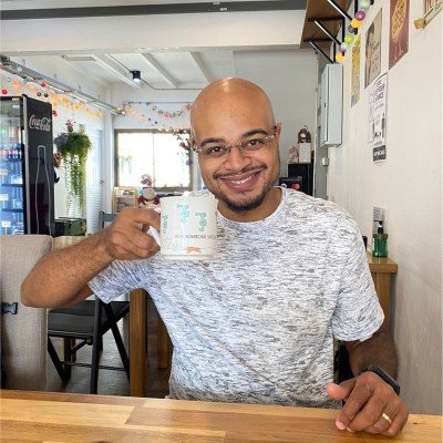 Brandon Richards, legal content writer, holding a coffee mug